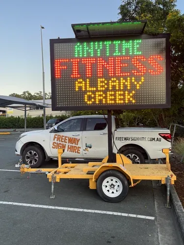 Five colour VMS sign hire — Anytime Fitness gym promotion dusk